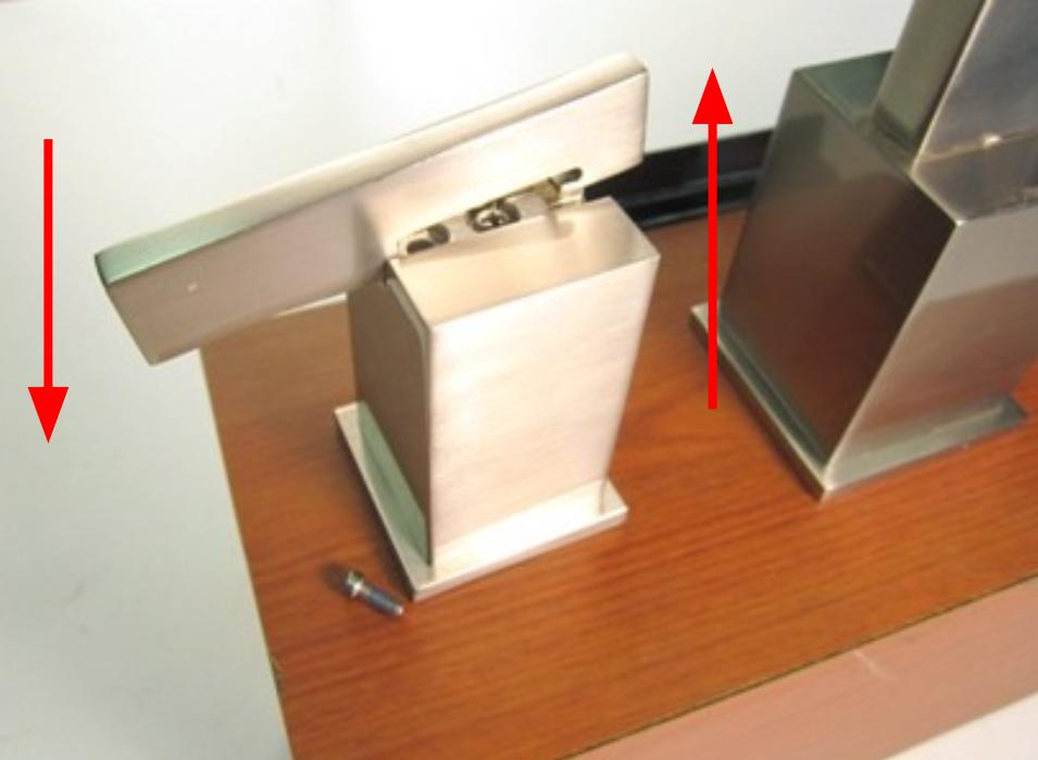 Once the set screw is loosened, slide the handle stem towards the spout and then push down on the end of the handle stem.