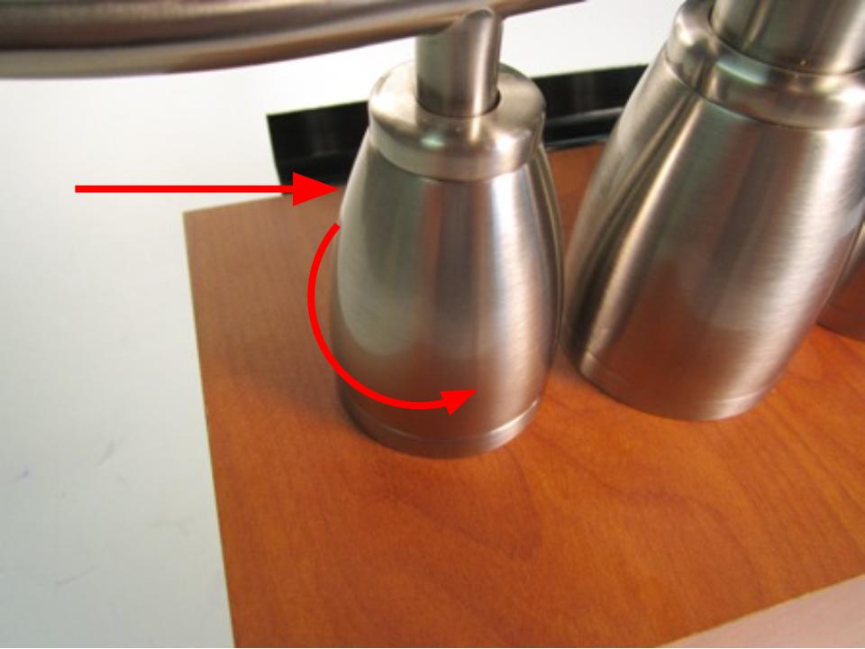 Hold the base of the faucet handle and turn counter clockwise until it is completely unscrewed.