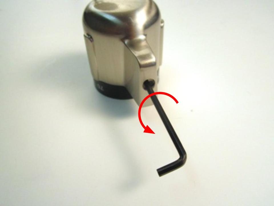 With the rubber cap removed, you should now have access to the set screw. Insert the hex wrench into the opening so that it engages the screw. Turn counter clockwise a quarter turn to loosen the set screw.