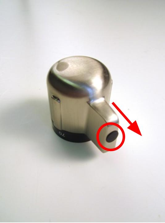 The opening for the set screw is covered by a black rubber cap. Remove this cap with your fingers.