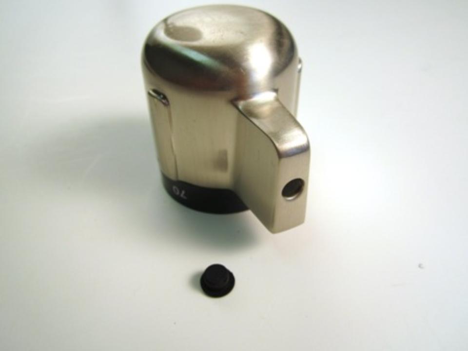 The opening for the set screw is covered by a black rubber cap. Remove this cap with your fingers.