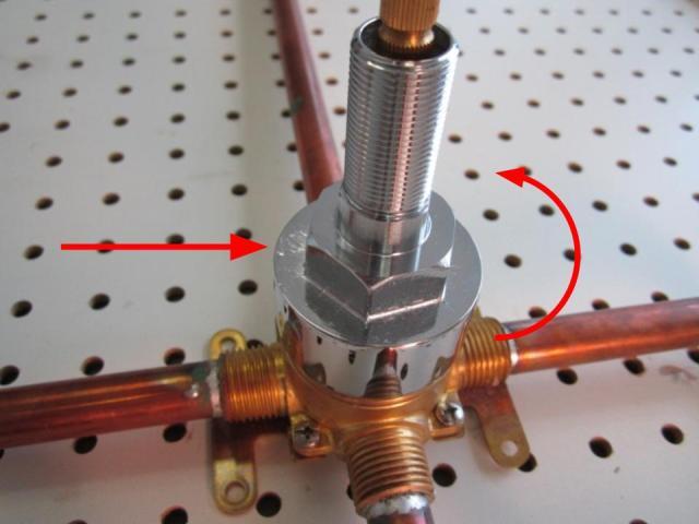 Using a pair of adjustable pliers, remove the base nut by unscrewing counter-clockwise.