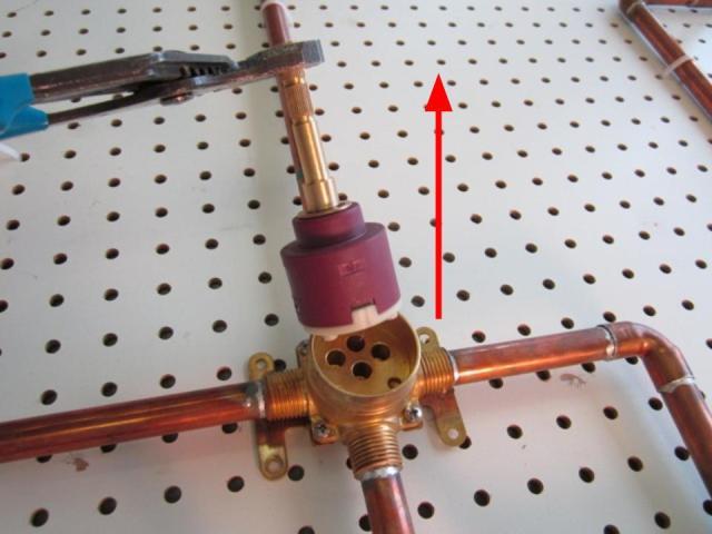 Hold the stem of the cartridge and pull out until the cartridge is completely removed from the faucet body.