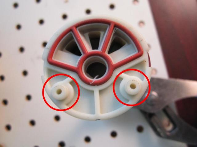 Locate the locating pins on the bottom of the cartridge