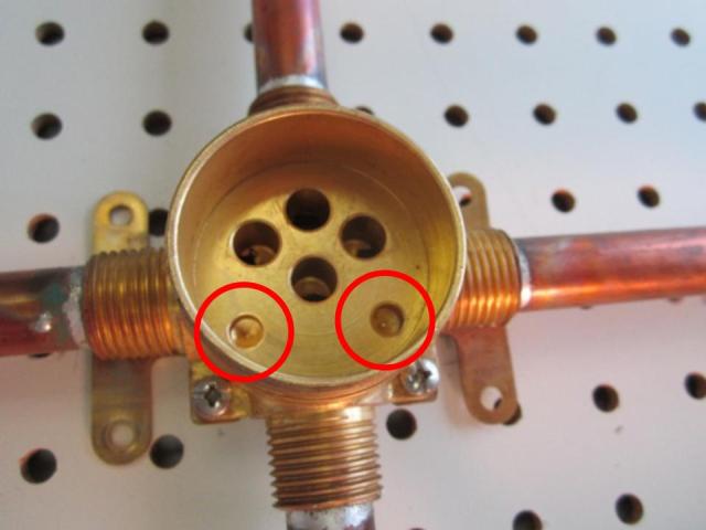Locate the corresponding holes in the faucet body