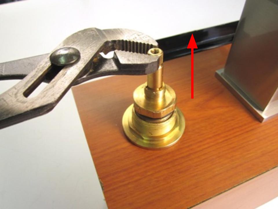 Holding the stem of the cartridge, pull up until the cartridge is completely removed from the faucet body.