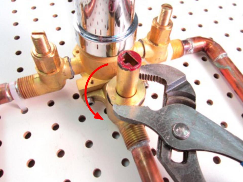 The diverter can now be removed. In order to do so, use a pair of adjustable plyers to remove the retainer nut. Turn counter clockwise in order to remove it.