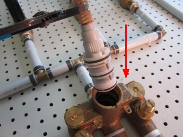 Using a pair of adjustable pliers, hold the cartridge and pull up until it is complete removed from the faucet body.