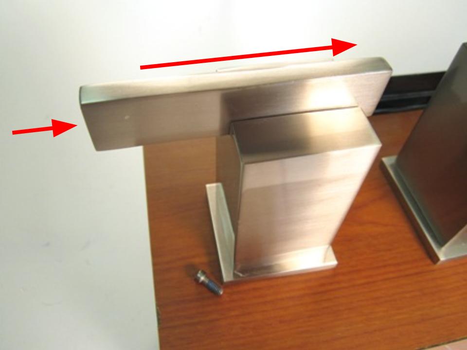 Once the set screw is loosened, slide the handle stem towards the spout and then push down on the end of the handle stem.