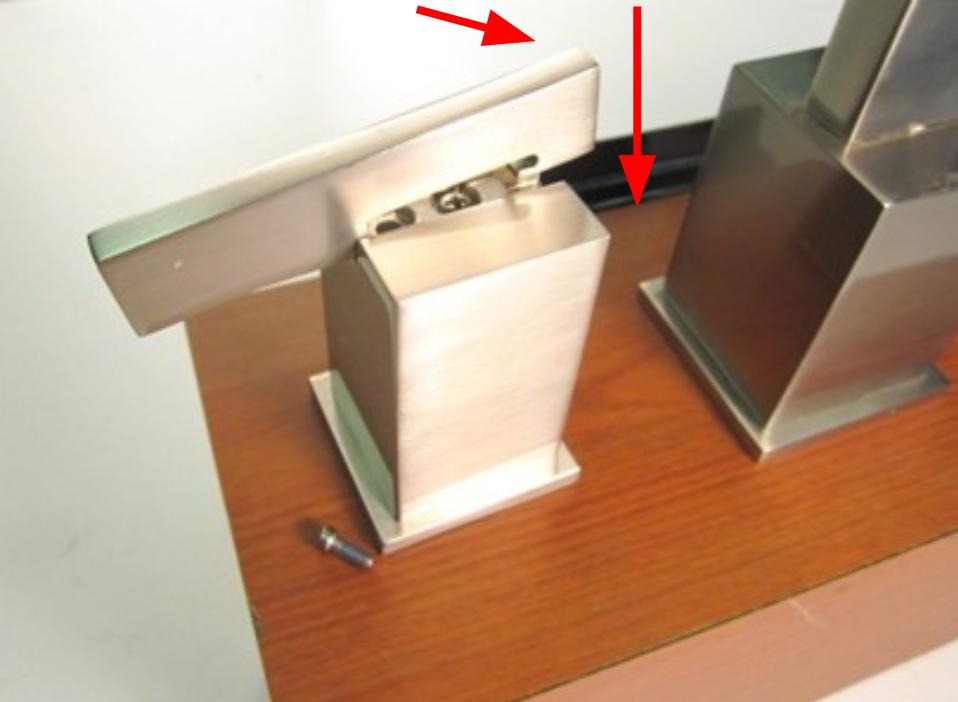 Push the raised portion of the handle stem down and into the handle base.